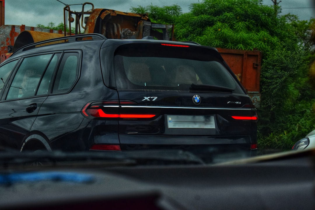 A black BMW x7 is seen in this photo.