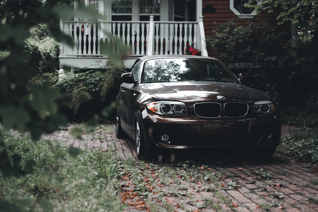 black bmw m 3 parked near white house during daytime