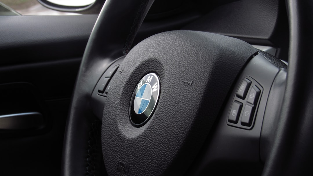 close-up photography of black BMW vehicle steering wheel