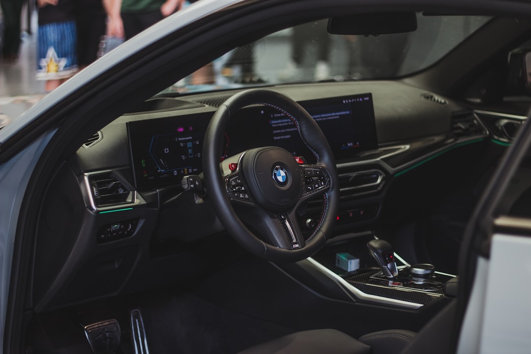 the interior of a car with a steering wheel and dashboard