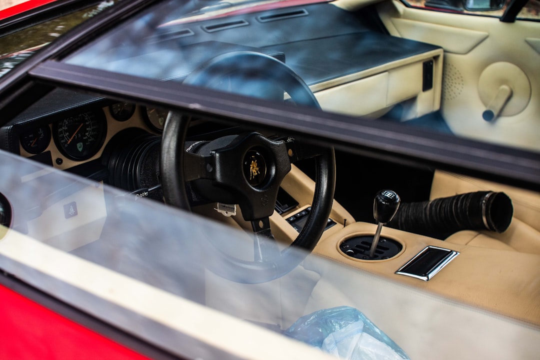 The interior of a car with a steering wheel and dashboard