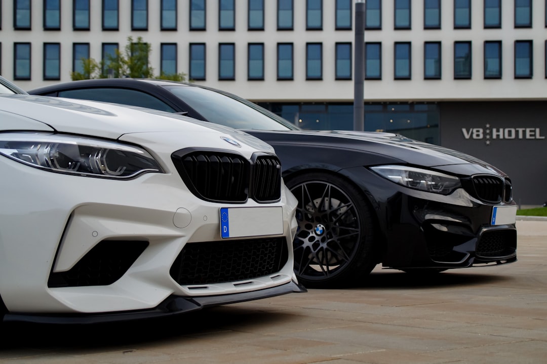 two cars parked next to each other in front of a building