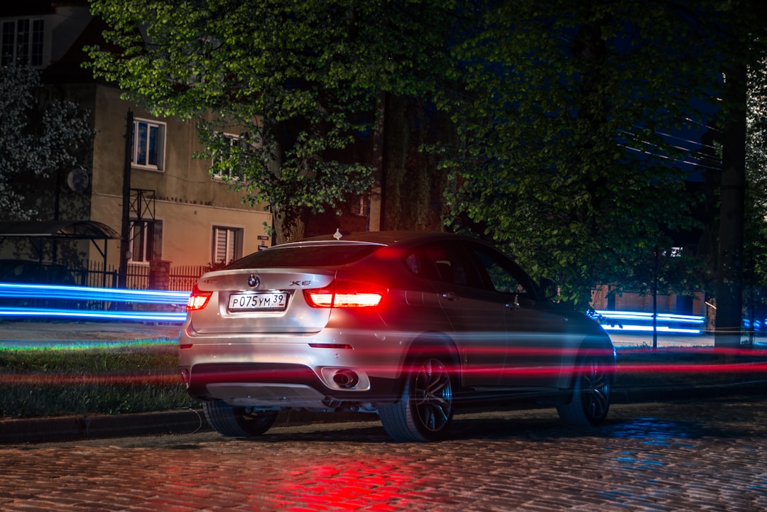 red bmw m 3 parked on sidewalk during daytime