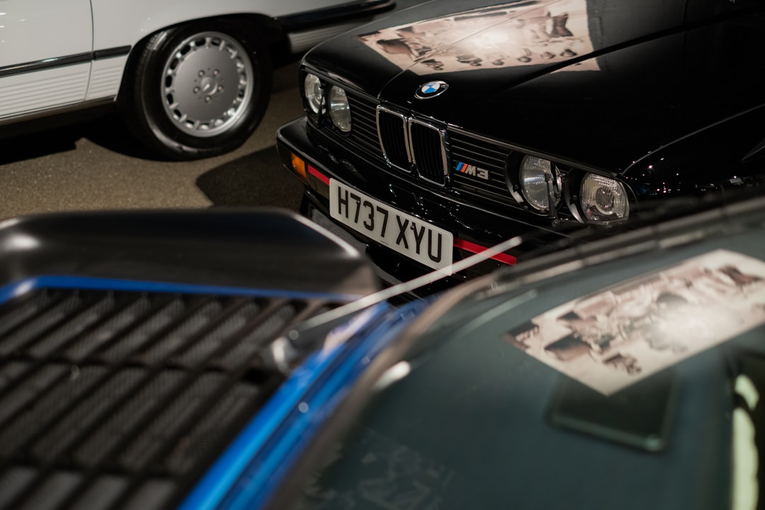Classic cars are parked close together at night.