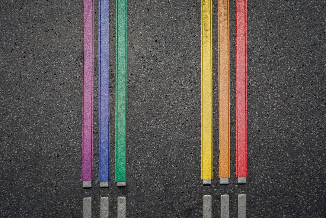 a row of colored pencils sitting next to each other