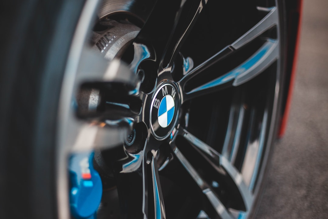 shallow focus photography of black and blue BMW car wheel