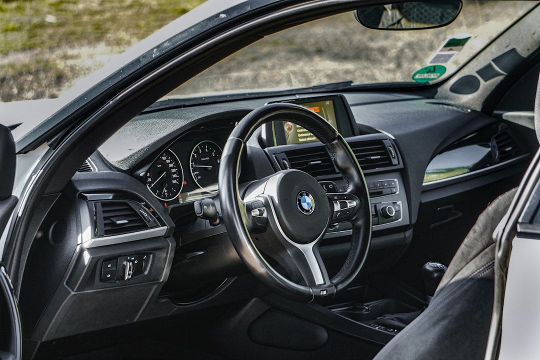 the interior of a car with a steering wheel and dashboard