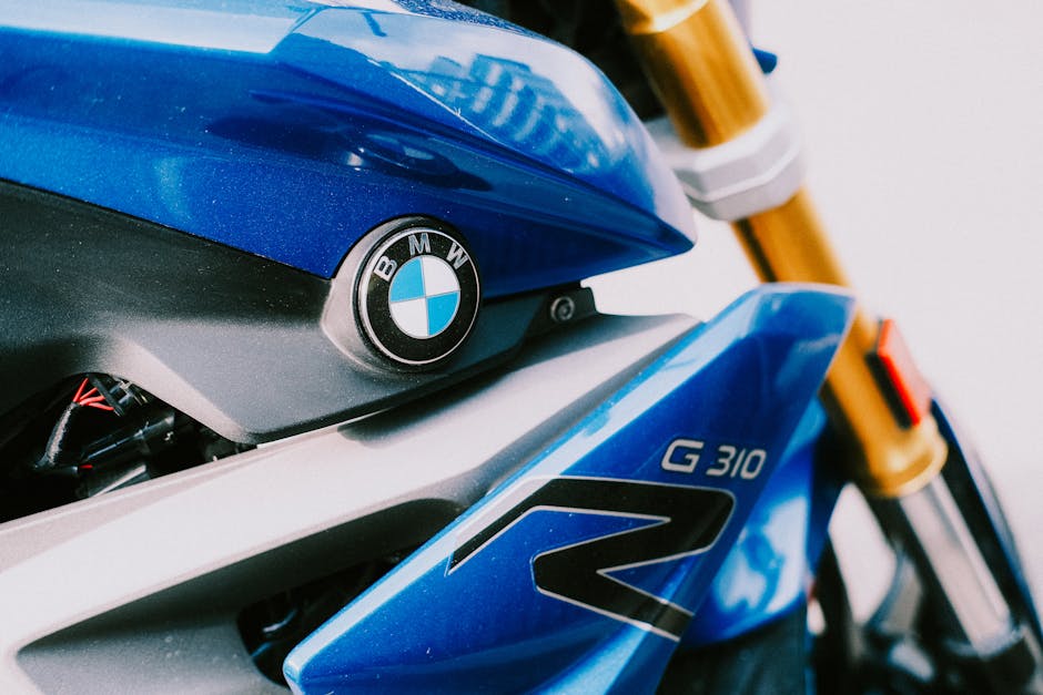 Detailed view of a blue BMW G310R motorcycle showcasing its design and branding.