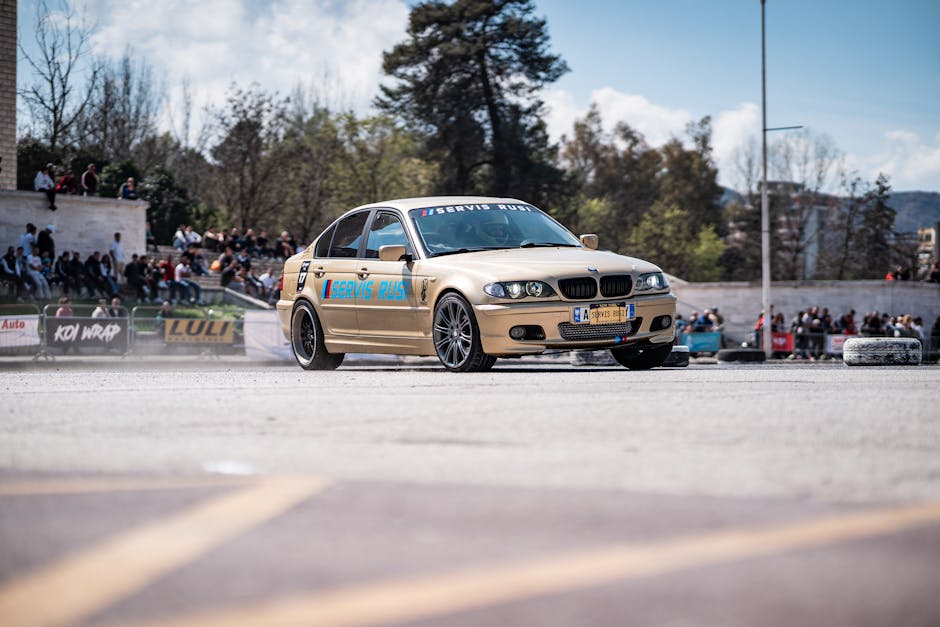 A BMW E46 car performing a drift on an outing during a motorsport event with an audience watching.
