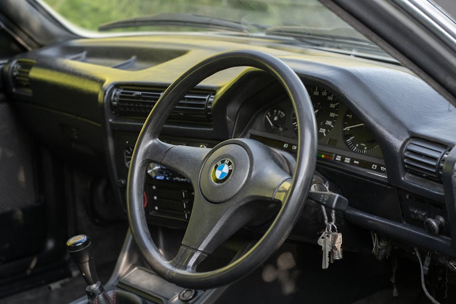 Close-up view of a BMW car interior highlighting the steering wheel and dashboard.