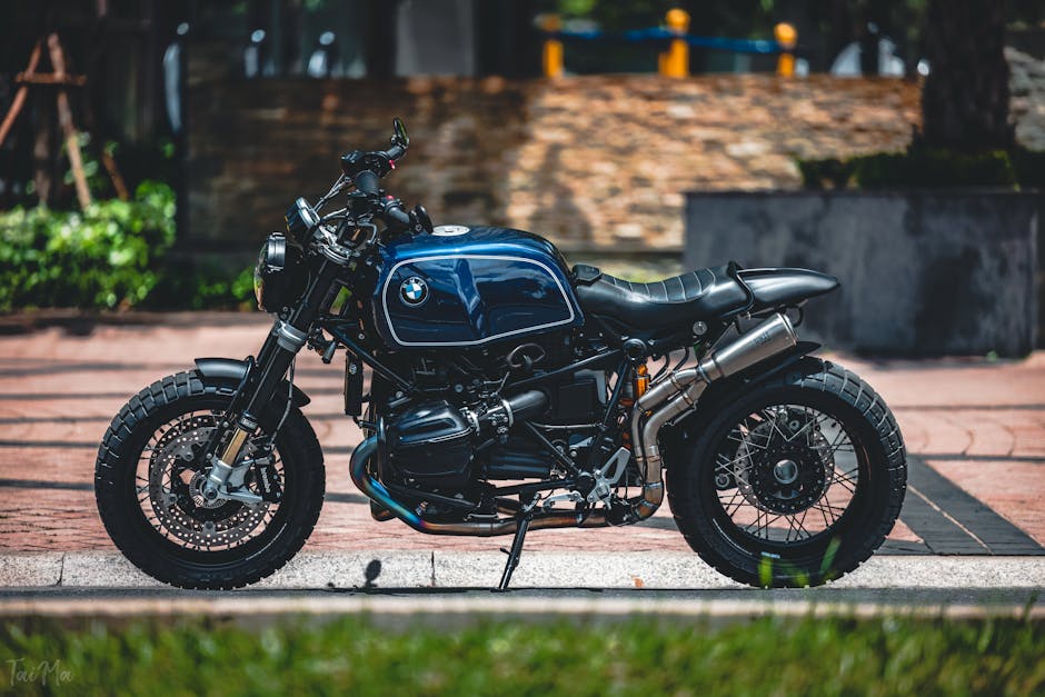 A modern BMW motorcycle parked in a sunny outdoor setting, showcasing its sleek design.