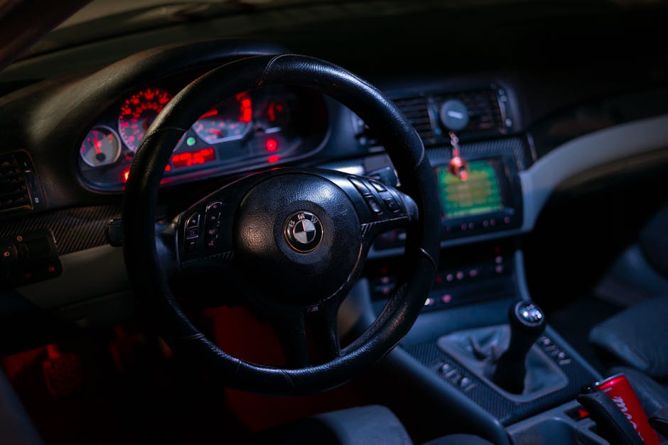 Detailed view of BMW car interior focusing on the steering wheel and dashboard.