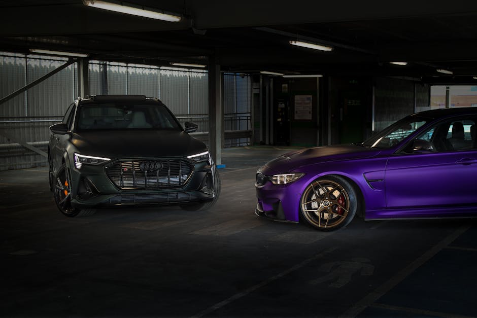 Two luxurious cars, an Audi and a BMW, parked in an indoor garage showcasing elegance and style.