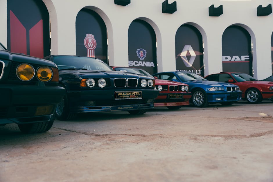 A collection of classic BMW cars displayed outdoors in Benghazi, Libya, featuring iconic models.
